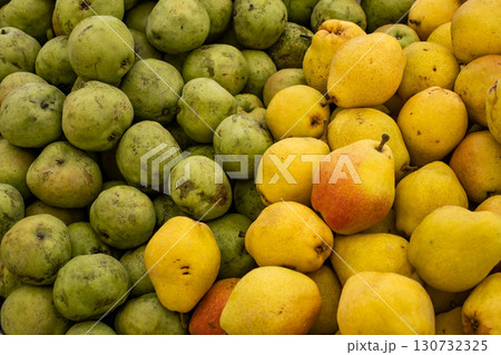 green and yellow pears at the market, top view 130732325