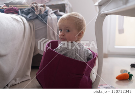 toddler girl playing in a box in the living room toddler girl playing in a box in the living room 130732345