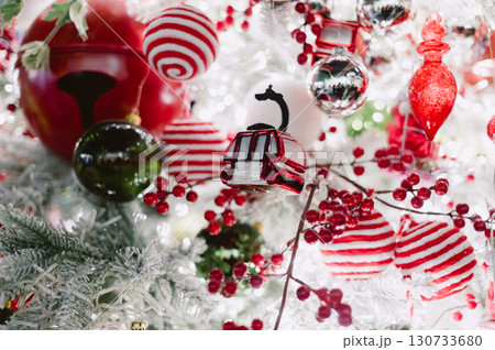 A Christmas tree with many ornaments including a red and white train 130733680