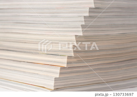 A stack of papers with the top one being the thinnest 130733697