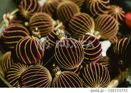A bunch of red and gold striped balls A bunch of red and gold striped balls 130733755