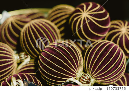 A bunch of red and gold striped balls A bunch of red and gold striped balls 130733756