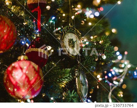 A Christmas tree with a balloon shaped ornament hanging from it 130733764