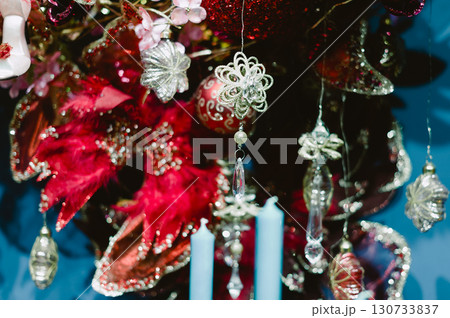 A Christmas tree with many ornaments and candles A Christmas tree with many ornaments and candles 130733837