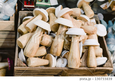 A pile of wooden mushroom shaped items 130733839