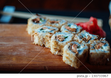 A plate of sushi with a variety of ingredients including avocado, cucumber 130733967
