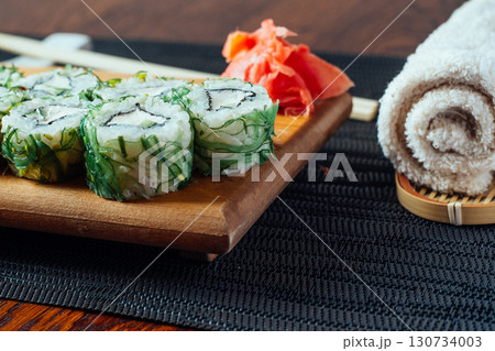 A plate of sushi with a towel next to it A plate of sushi with a towel next to it 130734003