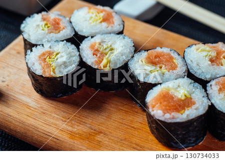 A sushi roll with a black and white pattern on it 130734033