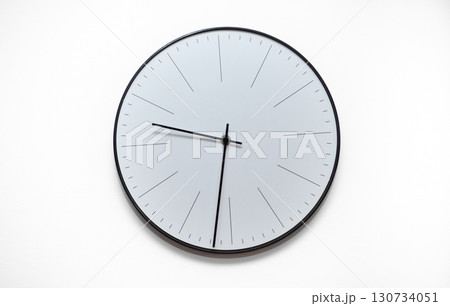 A clock with the hands on the number 3 and 9 130734051