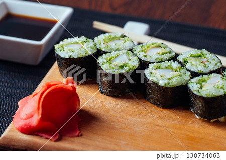 A plate of sushi with a red flower on it A plate of sushi with a red flower on it 130734063
