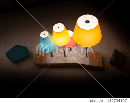 A table with three lamps on it, one of which is yellow A table with three lamps on it, one of which is yellow 130734107