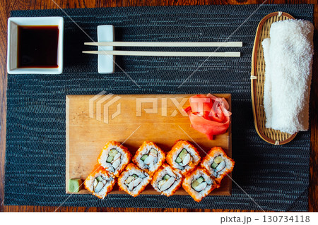 A tray of sushi with chopsticks and a napkin A tray of sushi with chopsticks and a napkin 130734118
