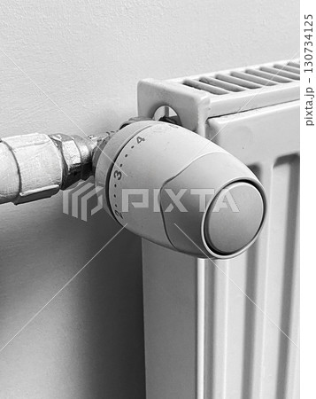 A radiator with a thermostat on it A radiator with a thermostat on it 130734125