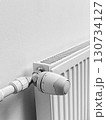 A radiator with a thermostat on it 130734127