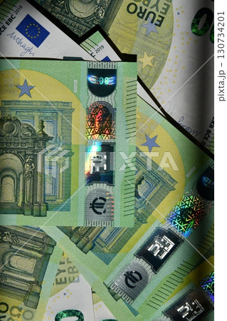 Euro banknote display with spectrum pattern across multiple denominations, showcasing currency features and design elements typical of EU money 130734201