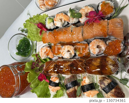 decorate the plate with ears with microgreens, edible flowers and red caviar 130734361