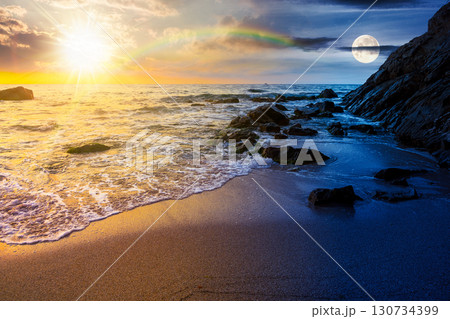 seascape on summer solstice at twilight. sea beach landscape beneath a sky with sun and moon. day and night time change concept. purity in nature. celebrating midsummer pagan holiday at the sea 130734399