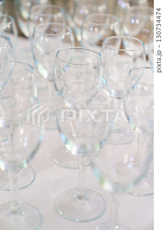 Lots of empty, clean glasses on the table. Lots of empty, clean glasses on the table. 130734474