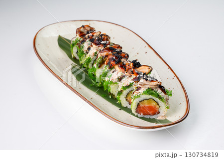 Delicious Japanese fusion sushi roll with salmon, mussels, chuka seaweed, pickled radish 130734819