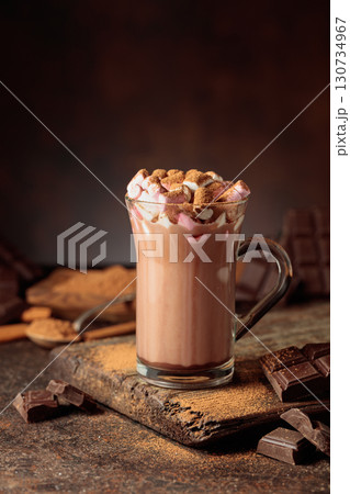 Hot chocolate drink with marshmallows sprinkled with cocoa powder. 130734967