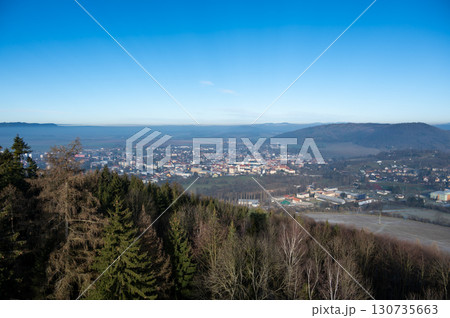 Aerial view of Moravska Trebova with its scenic panorama. The town is surrounded by rolling hills and dense forests, showcasing the harmony of historic architecture and Czech nature Aerial view of Moravska Trebova with its scenic panorama. The town is surrounded by rolling hills and dense forests, showcasing the harmony of historic architecture and Czech nature 130735663
