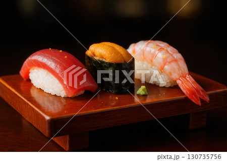 Sushi Nigiri Trio With Tuna, Uni Gunkan, And Shrimp On Wooden Geta 130735756