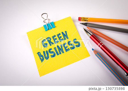Green Business message written on yellow paper with stationery Green Business message written on yellow paper with stationery 130735898