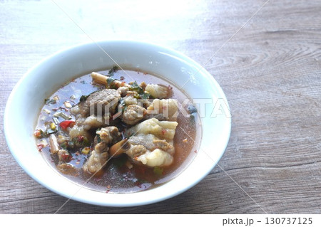 boiled slice braised beef meat with chili in clear tom yum soup on bowl  130737125