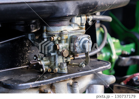 Vintage automobile carburetor detail, showcasing its intricate mechanical engineering and classic industrial design, ideal for car restoration, engine maintenance, and historical automotive projects Vintage automobile carburetor detail, showcasing its intricate mechanical engineering and classic industrial design, ideal for car restoration, engine maintenance, and historical automotive projects 130737179