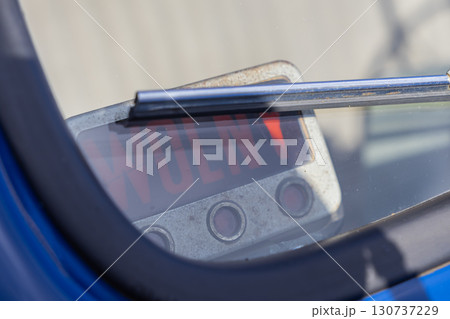 Vintage car dashboard detail shows a metallic panel with visible 'WOLNY' text, reflecting an available status for old vehicle transport or taxi service Vintage car dashboard detail shows a metallic panel with visible 'WOLNY' text, reflecting an available status for old vehicle transport or taxi service 130737229