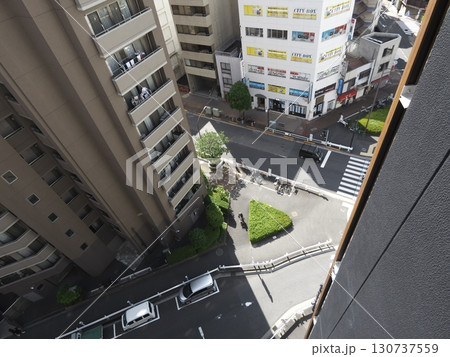 高層ビルに囲まれた都会の三角地帯と行き交う人々の光景 高層ビルに囲まれた都会の三角地帯と行き交う人々の光景 130737559