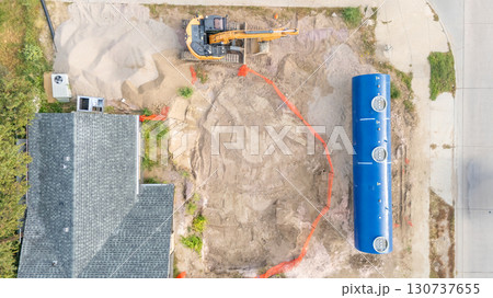 Aerial view of a construction site installing a new underground storage tank at a gas station. Aerial view of a construction site installing a new underground storage tank at a gas station. 130737655