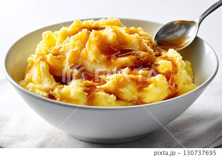 Bowl of mashed potatoes with gravy, isolated on white background, spoon inside, homemade rustic style 130737695