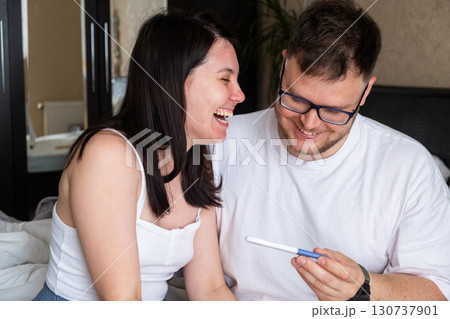 Happy Couple Celebrating Positive Pregnancy Test 130737901