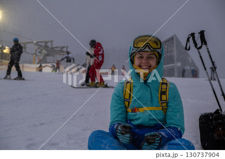 Skier Resting on Snowy Slope at Ski Resort 130737904