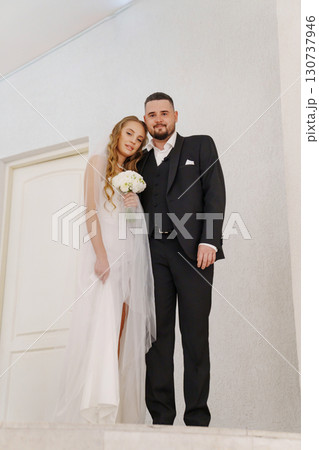The bride and groom are in the lobby of the Wedding Palace. The bride and groom are in the lobby of the Wedding Palace. 130737946