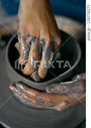 Hands of craftsman artist working on pottery wheel. 130738272