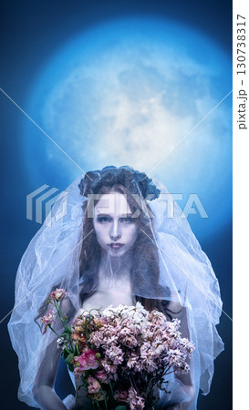 Gothic bride holding wilted bouquet under full moon surreal scene Gothic bride holding wilted bouquet under full moon surreal scene 130738317
