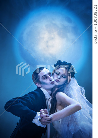 Gothic couple in dramatic moonlit dance with surreal atmosphere 130738321