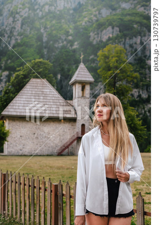 Woman Standing near Church of Theth in Albanian Alps 130739797