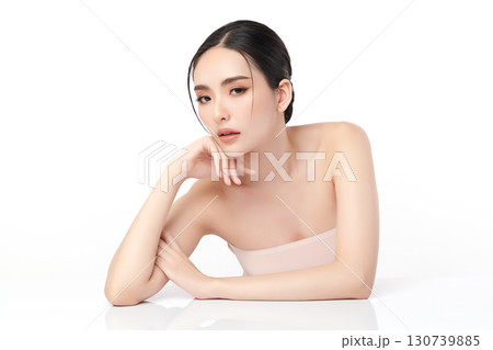 A beautiful young Asian woman with clean, fresh skin against a white background. Skincare, facial treatment, cosmetology, beauty, and spa. An elegant portrait of an Asian woman. 130739885