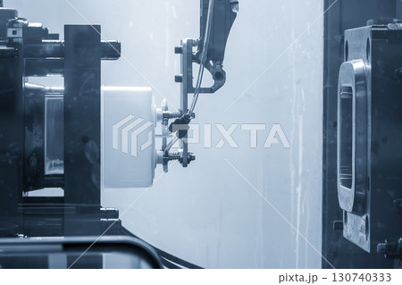 Close up scene material handling process the food container by robotic system from injection machine. 130740333