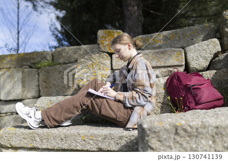 Archaeologist writing notes at excavation site 130741139