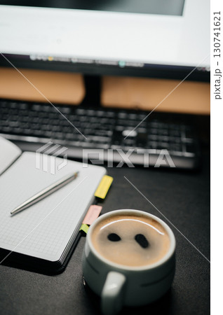 Cup of coffee on desk with notebook, smartphone and pen. Workspace concept, productivity and planning background. 130741621