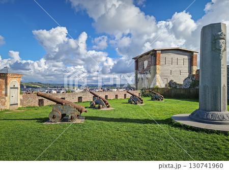 The castle grounds in Dieppe feature a grassy area with antique cannons positioned for defense in Normandy, France. 130741960