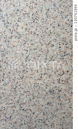 Detailed close-up of beige granite wall surface texture 130741984
