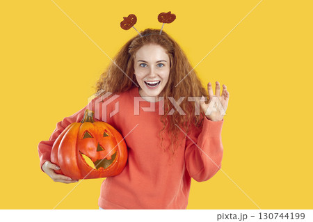 Portrait ofcheerful woman who funny shows scratching gesture while celebrating Halloween. Portrait ofcheerful woman who funny shows scratching gesture while celebrating Halloween. 130744199