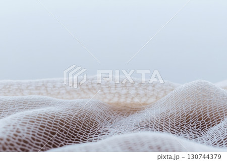 Soft white fabric draping in gentle waves with a calm background 130744379