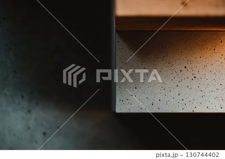 Modern concrete surface with warm lighting at a cozy kitchen setting Modern concrete surface with warm lighting at a cozy kitchen setting 130744402