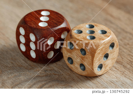 Two dice on wooden surface 130745292